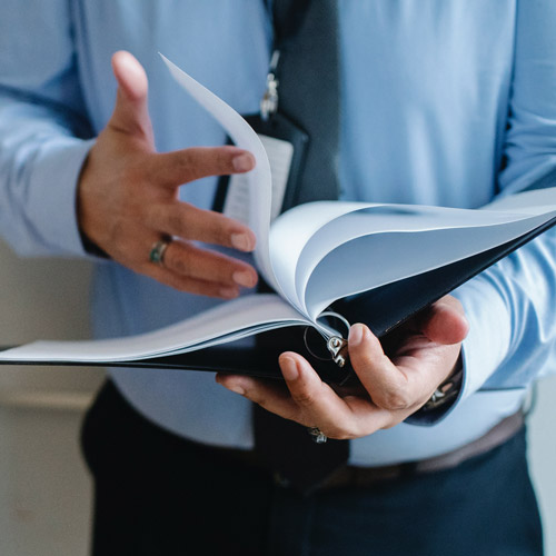 businessman goes through binder