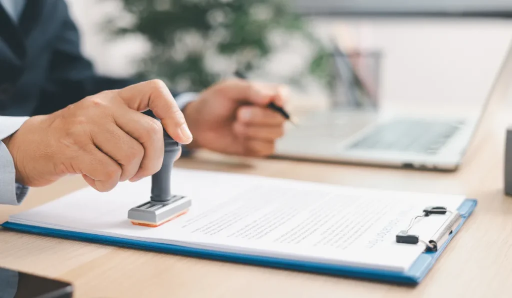 Judge holding a stamp over an official legal document.