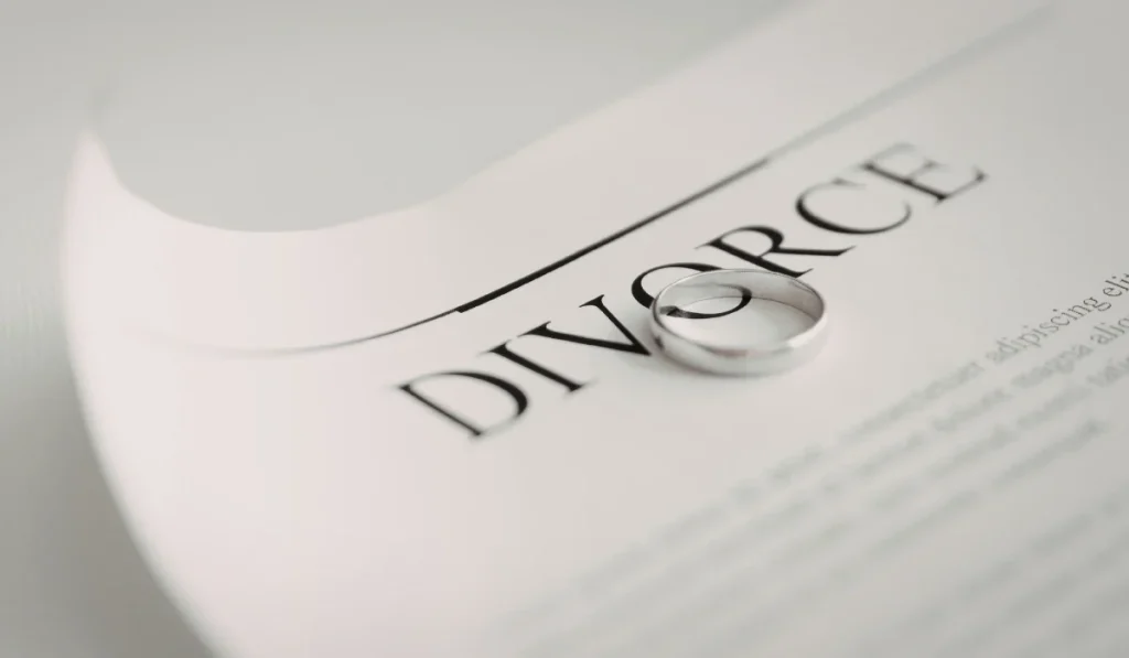 Wedding ring resting on a divorce document